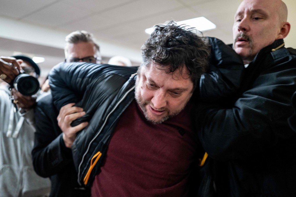 Anthony Kazmierczak is subdued after an attack on congresswoman Ilhan Omar during a town hall meeting in Minneapolis, Minnesota, on Tuesday. Photo: AFP