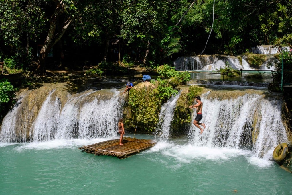 Tourists have fun in the Cambugahay Falls on the Philippine island of Siquijor on December 10 last year. Photo: AFP