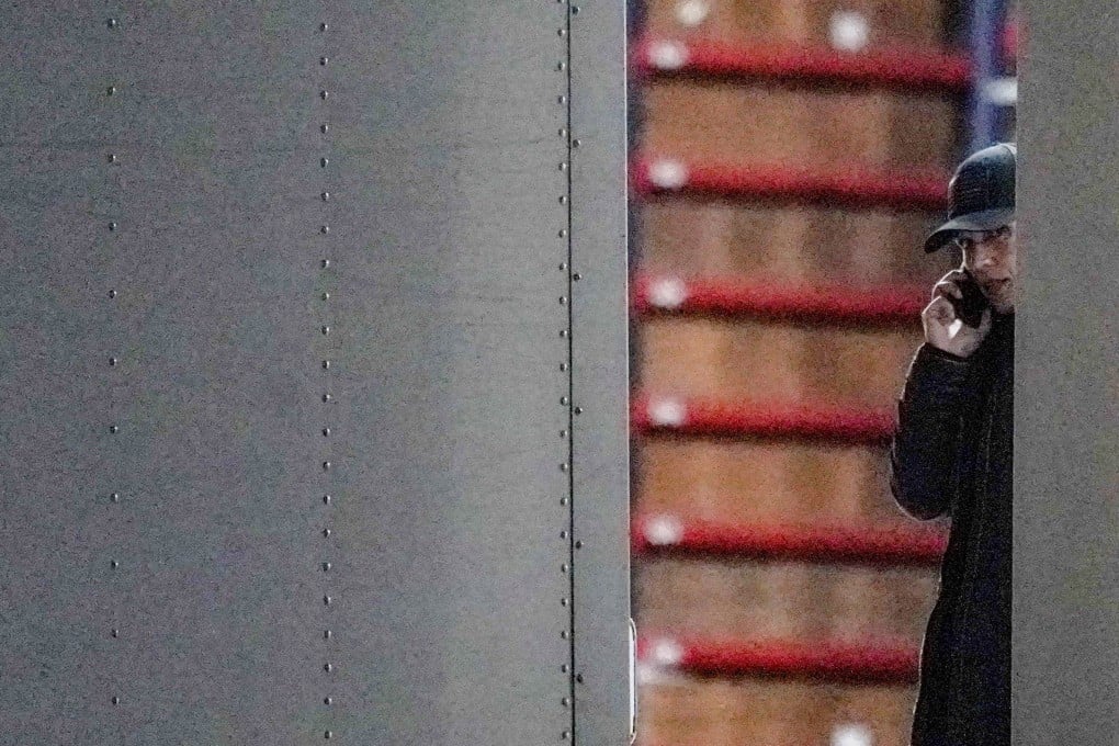 The US Director of National Intelligence Tulsi Gabbard speaks on the phone during the FBI raid in Georgia on Wednesday. Photo: Reuters