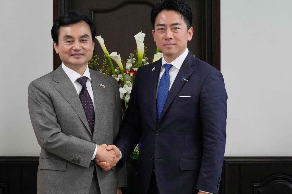 Japan’s Defence Minister Shinjiro Koizumi (right) and South Korea’s Defence Minister Ahn Gyu-back shake hands before their meeting at Japan’s Yokosuka naval base near Tokyo on Friday. Photo: AFP