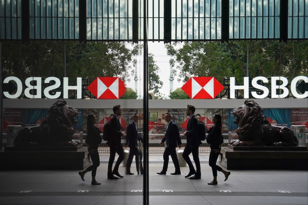Pedestrians walk past the lion statues outside HSBC’s Hong Kong headquarters in Central. Photo: Elson Li