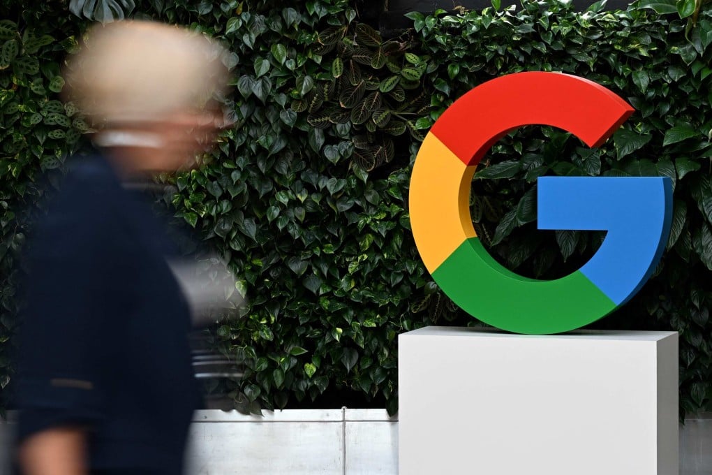 A woman walks past a Google logo at the company’s campus in Warsaw in February 2025. Photo: AFP