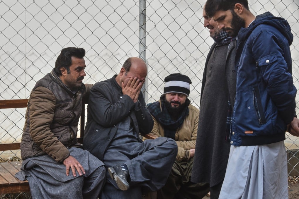Relatives of police officers killed in an attack by militants mourn outside a hospital in Quetta, Pakistan, on Saturday. Photo: AP