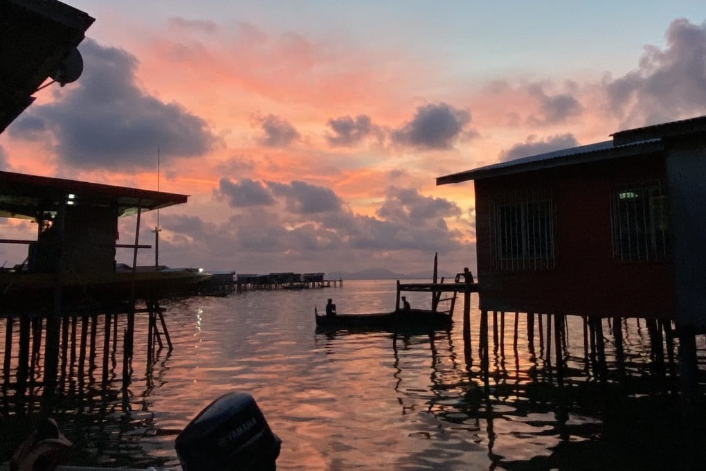 A fisherman goes out in his boat in Semporna, Sabah, Malaysia. Photo:  Ushar Daniele
