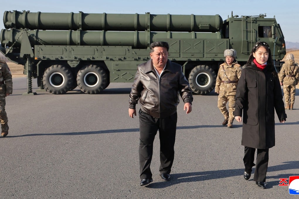 North Korean leader Kim Jong-un, accompanied by his daughter Kim Ju-ae, oversee a test-fire of a large-calibre multiple-rocket launcher system at an unknown location in North Korea. Photo: EPA/KCNA