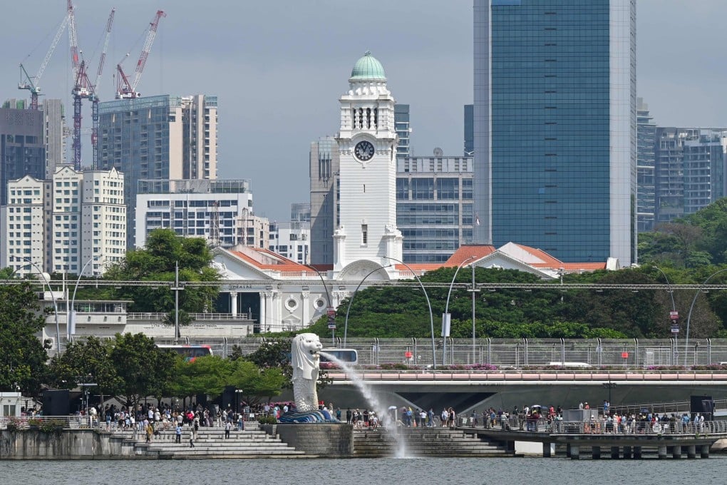 People gather around the Merlion statue at Marina Bay in Singapore. Photo: AFP