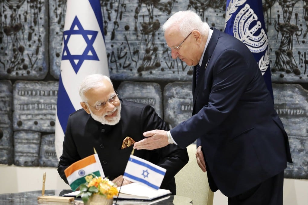 Israeli President Reuven Rivlin (right) gestures as Indian Prime Minister Narendra Modi sits to sign the guest book during a welcome ceremony in Jerusalem in 2017. Photo: AFP
