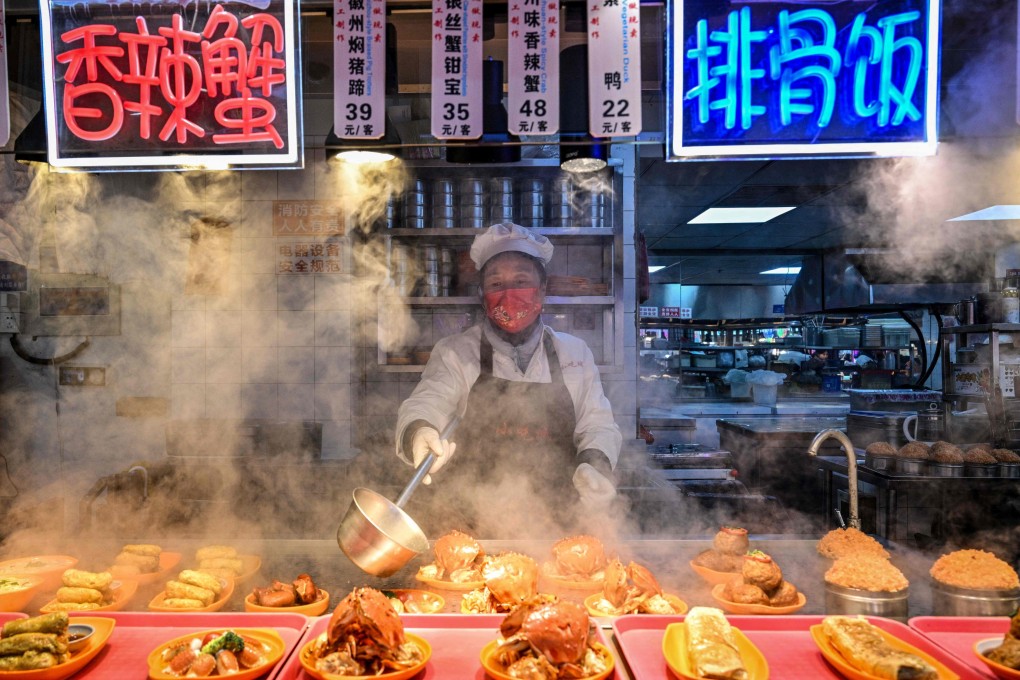 A food seller prepares dishes at a restaurant in Shanghai on January 21. Photo: AFP