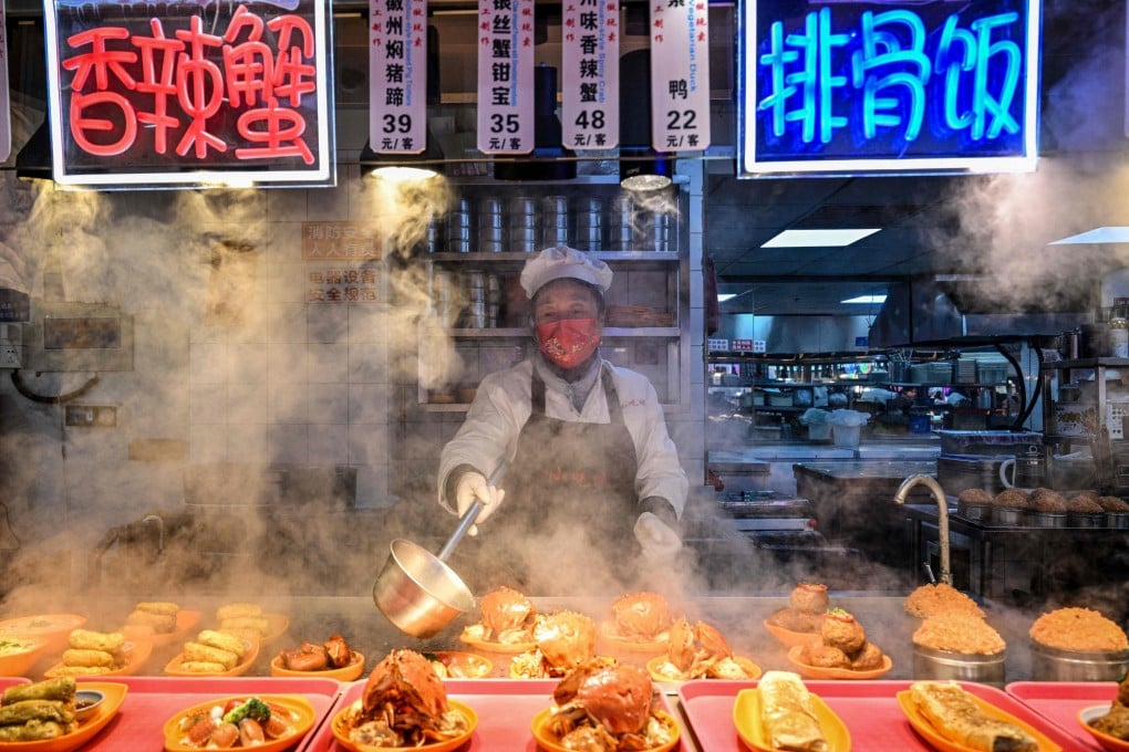 A food seller prepares dishes at a restaurant in Shanghai on January 21. Photo: AFP