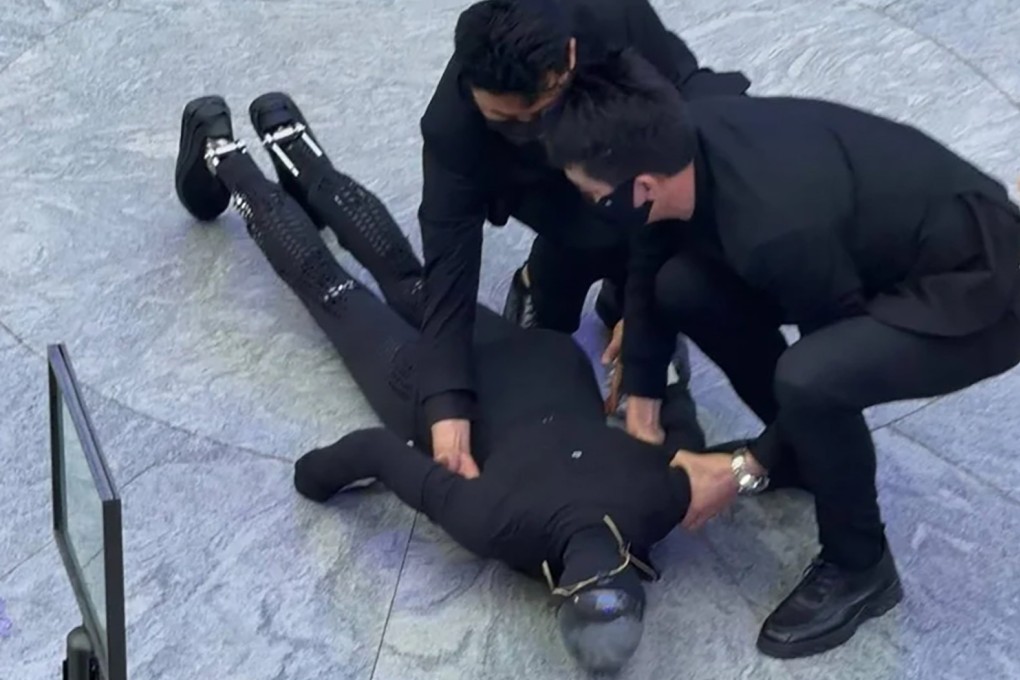 Staff members assist Xpeng’s Iron robot after its fall during a demonstration in Shenzhen. Photo: Handout