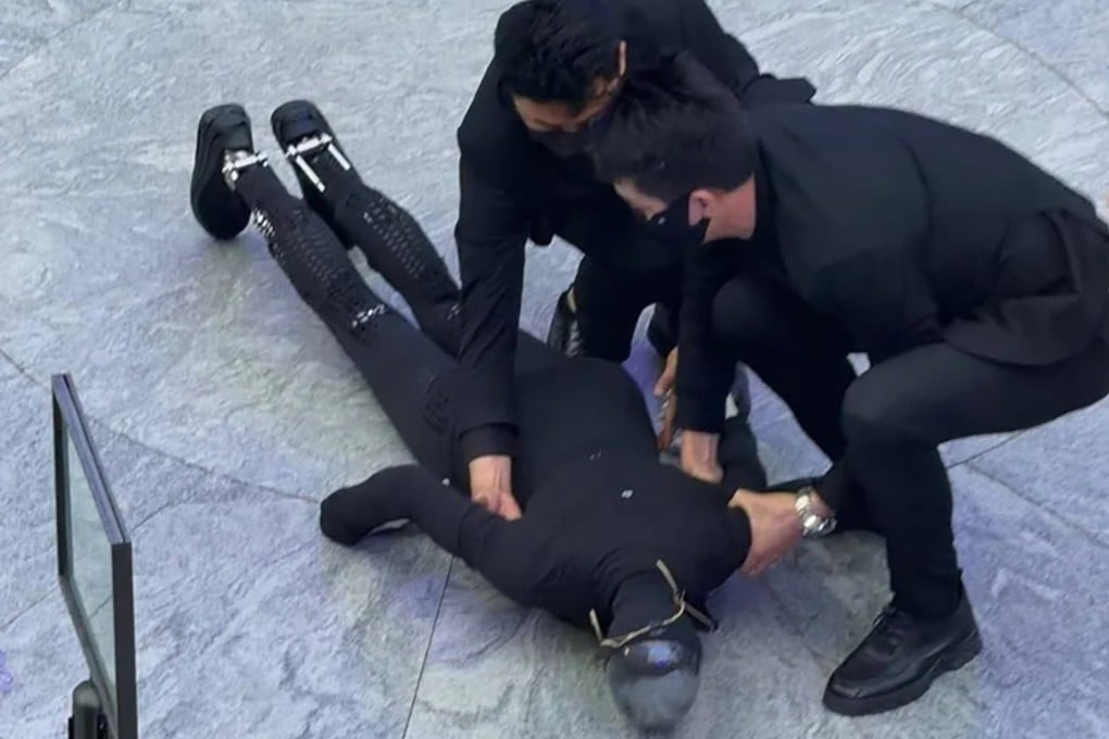 Staff members assist Xpeng’s Iron robot after its fall during a demonstration in Shenzhen. Photo: Handout