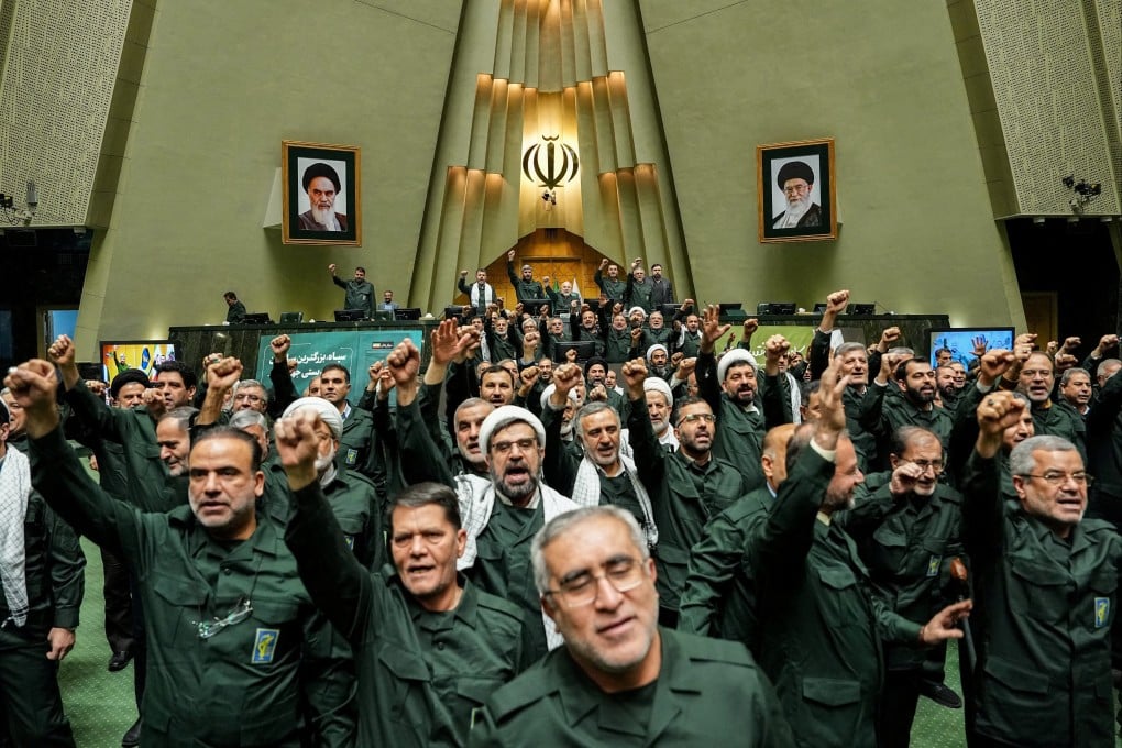 Iranian parliament members wearing military uniforms chant in support of the IRGC in Tehran on Sunday. Photo: West Asia News Agency via Reuters