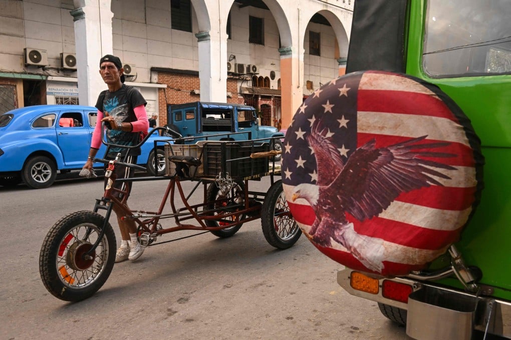 A man pushes a tricycle in Havana, Cuba. Photo: AFP
