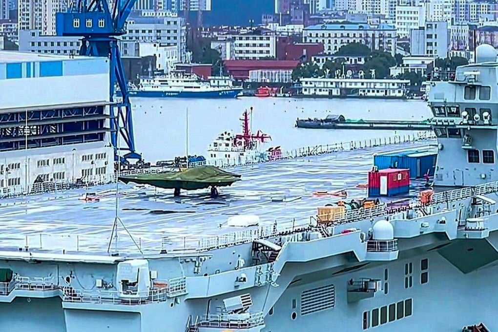What appears to be a covered GJ-21 stealth drone is seen on the deck of the Sichuan, China’s first Type 076 amphibious assault ship. Photo: Handout
