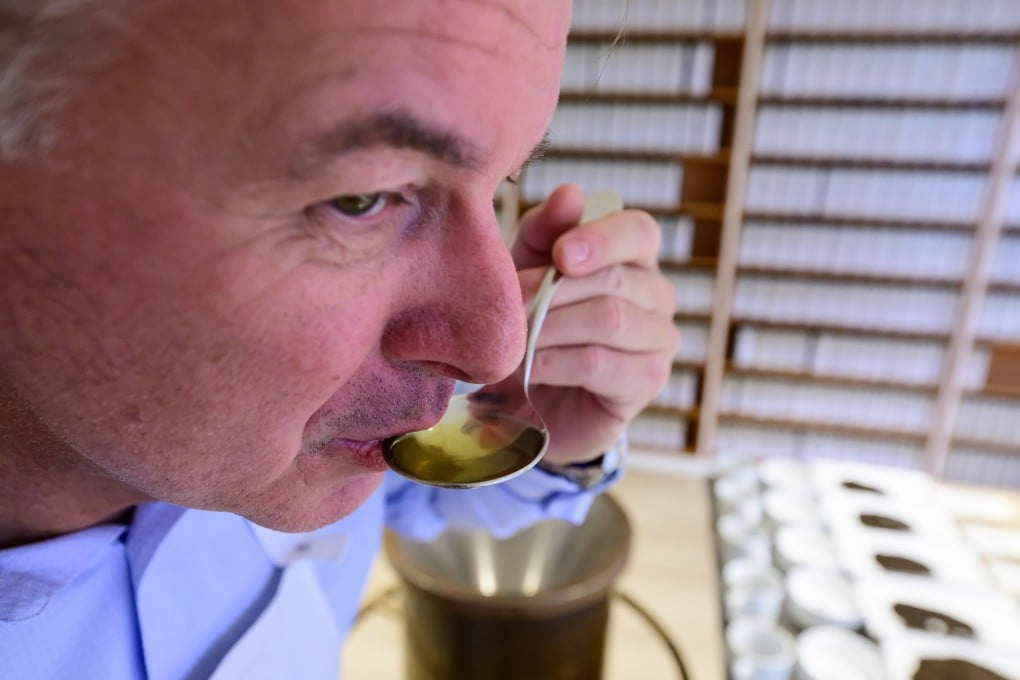 German tea taster Stefan Feldbusch samples a spoonful of tea. The inhabitants of Frisia, in northwestern Germany, drink more tea than beer. Photo: Philipp Schulze/dpa