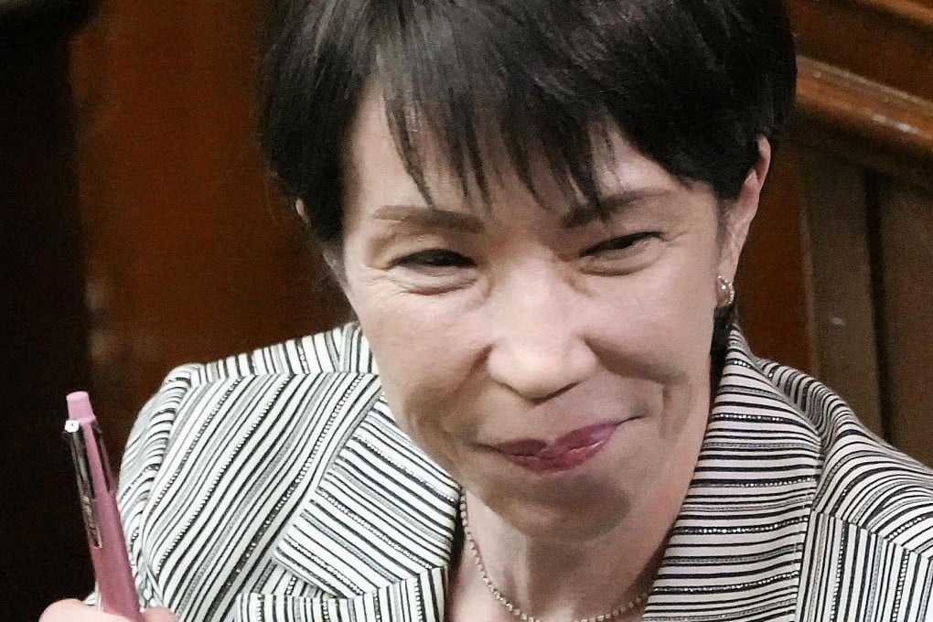 Japan’s Prime Minister Sanae Takaichi holds up her personal pen at a House of Representatives session in November last year. Photo: Kyodo/AP