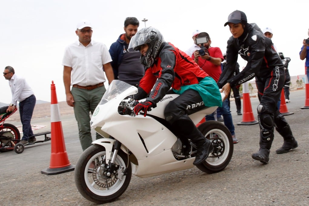 Maryam Talaie helps actress Katayun Riyahi during Iran’s first official women’s motorcycle training near Tehran in 2018. As of Wednesday, women in the country can officially get motorcycle licenses. Photo: EPA-EFE