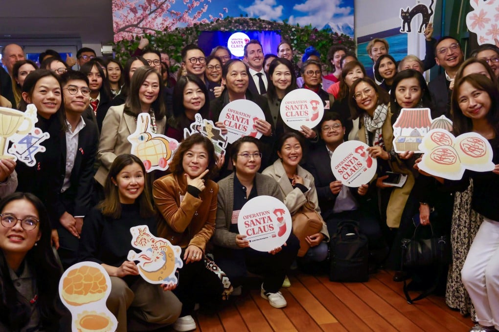 SCMP publisher Tammy Tam and RTHK radio controller Angel Cheng (middle row, third and fourth from left) at the Operation Santa Claus closing ceremony at Cafe 8 on February 3. Photo: Jonathan Wong