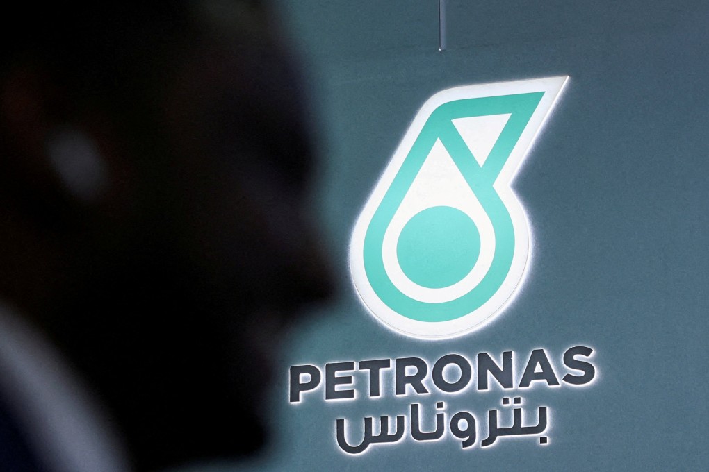 A man walks past a Petronas logo during the annual Abu Dhabi International Petroleum Exhibition and Conference in November last year. Photo: Reuters