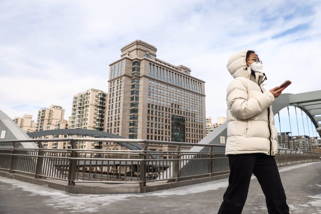 A woman walks near residential buildings in Beijing, China, on January 19. Photo: EPA