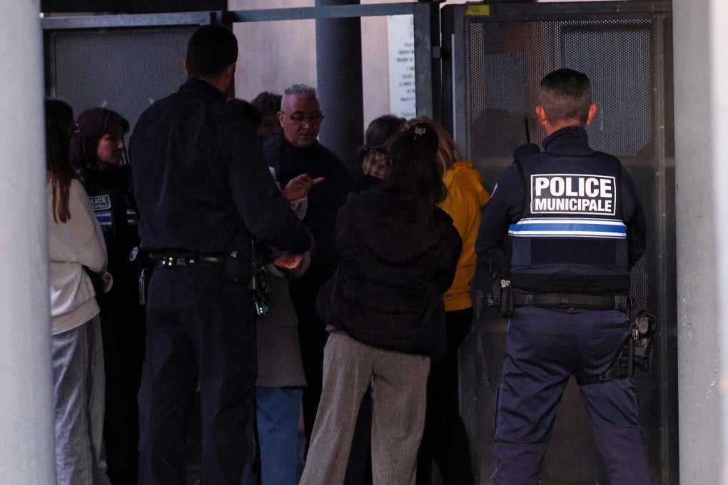 Police talk to students after the stabbing at La Guicharde secondary school. Photo: Reuters