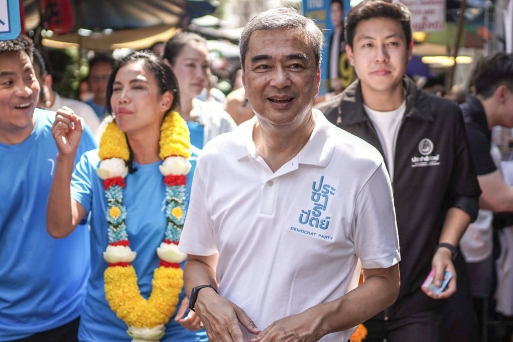 Democrat Party prime ministerial candidate Abhisit Vejjajiva (centre) walks through a market in Bangkok during an election campaign rally on January 27. Photo: Reuters