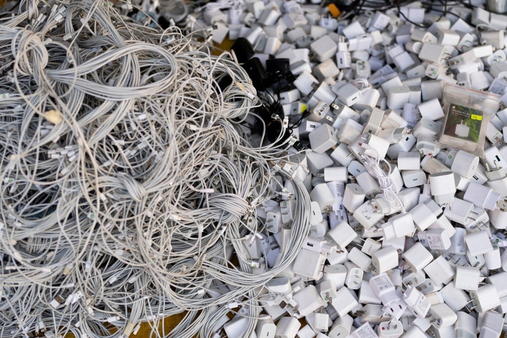 Used charging cables and power adapters are piled up at a shop in Nhat Tao market, Vietnam. Photo: AP