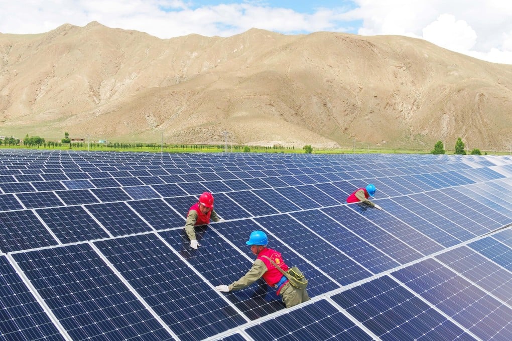 Maintenance staff check solar panels at a facility in China’s Tibet autonomous region. Photo: Getty Images
