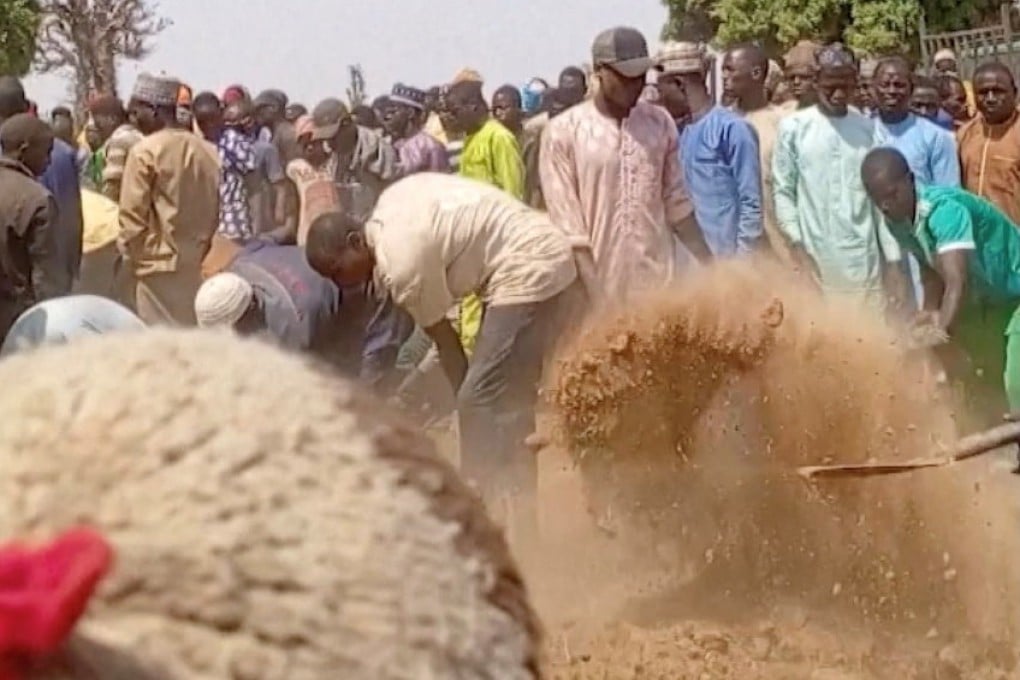 People dig graves after a deadly attack by an armed gang in Katsina, Nigeria. Photo: Reuters TV