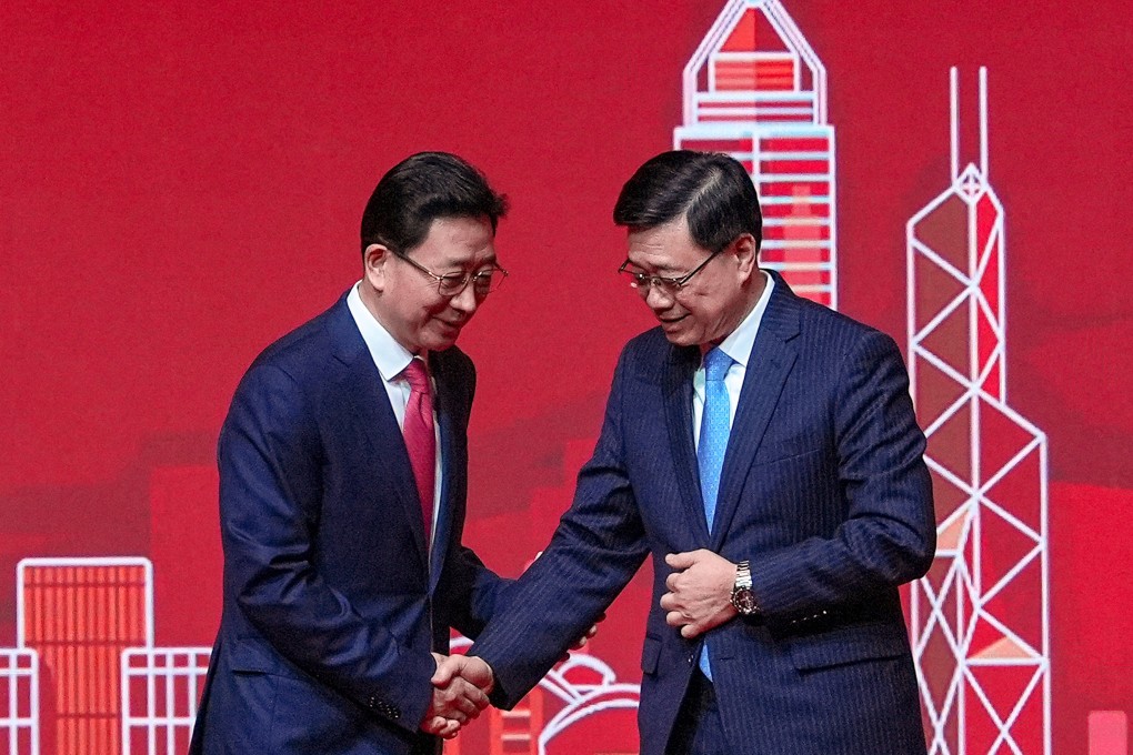 Liaison office director Zhou Ji (left)  with Chief Executive John Lee at the Lunar New Year reception. Photo: Elson Li