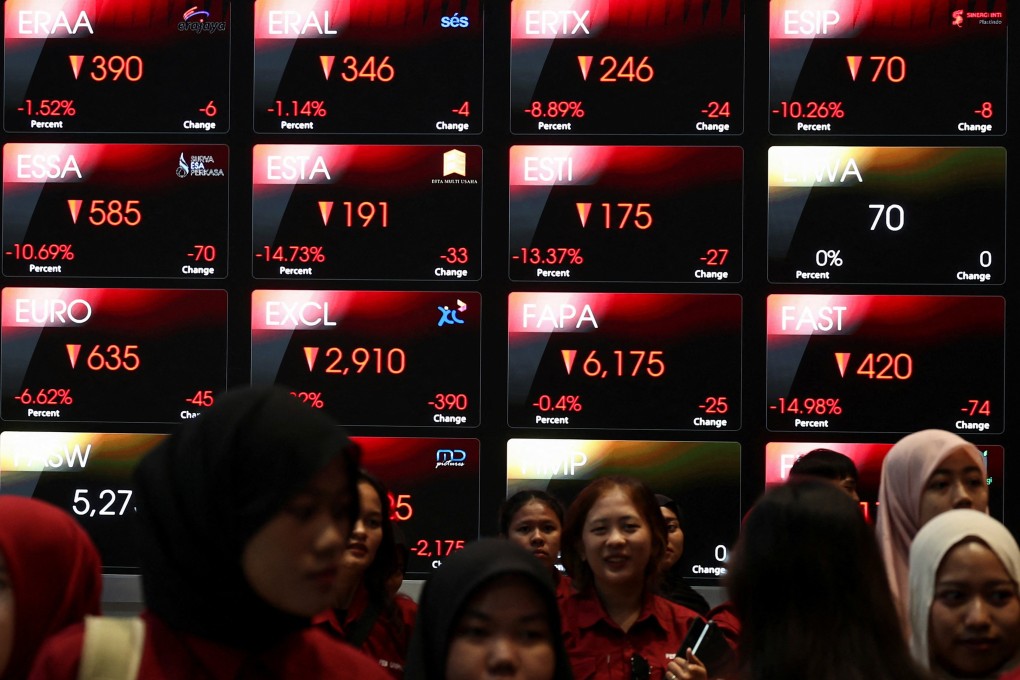 Students walk past an electronic board showing stock market index at the Indonesia Stock Exchange in Jakarta on Monday. Photo: Reuters