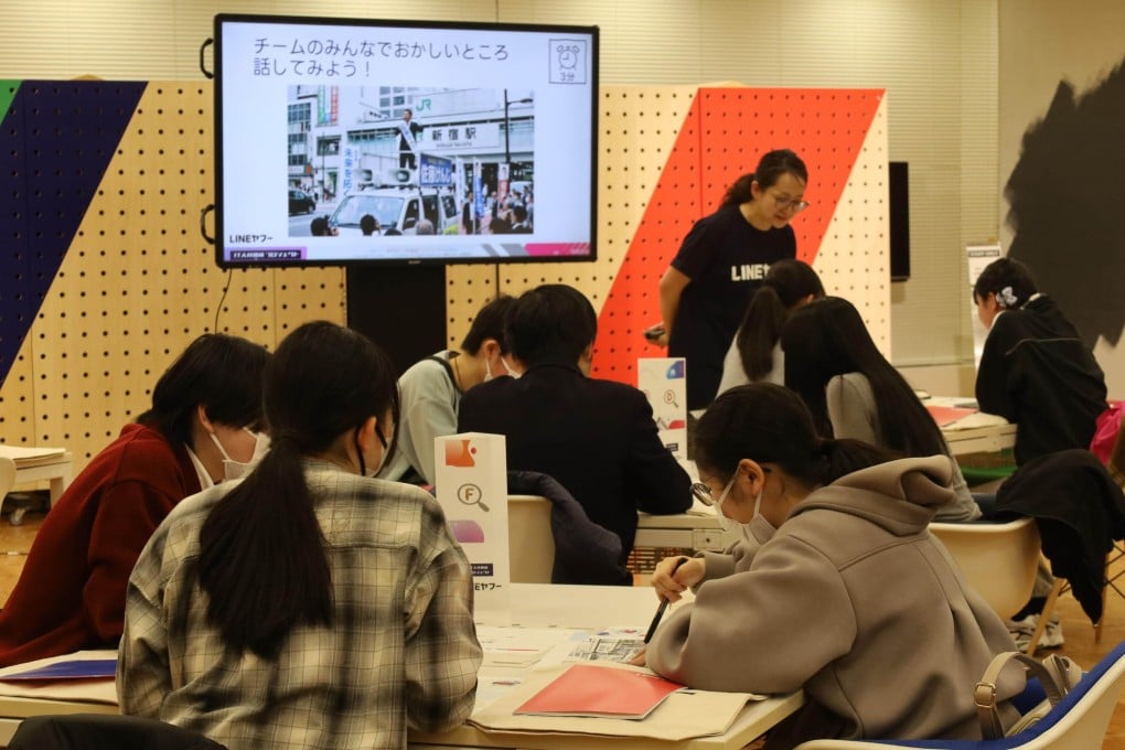 Students participate in a workshop on misinformation and disinformation, where an image created by generative AI is displayed and analysed, in Tokyo on Wednesday. Photo: Kyodo