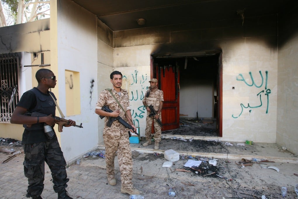 Libyan military guards check one of the US government’s burnt-out buildings in September 2012 in Benghazi, Libya. Photo: AP