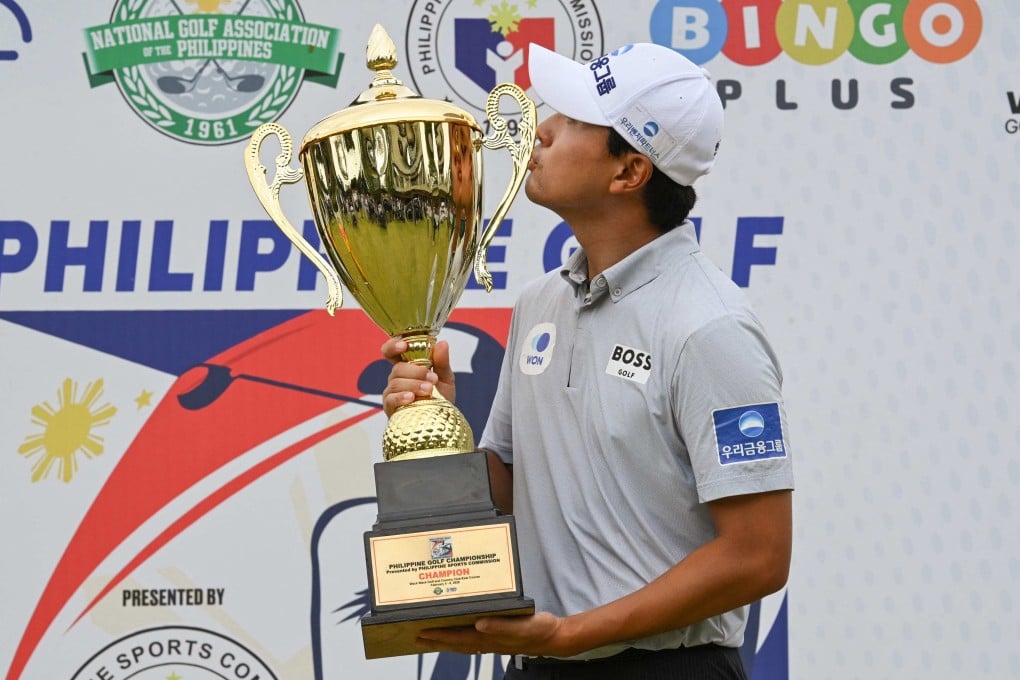 Cho Woo-young of South Korea kisses the trophy after winning the Philippines Golf Championship by four shots in Manila. Photo: AFP