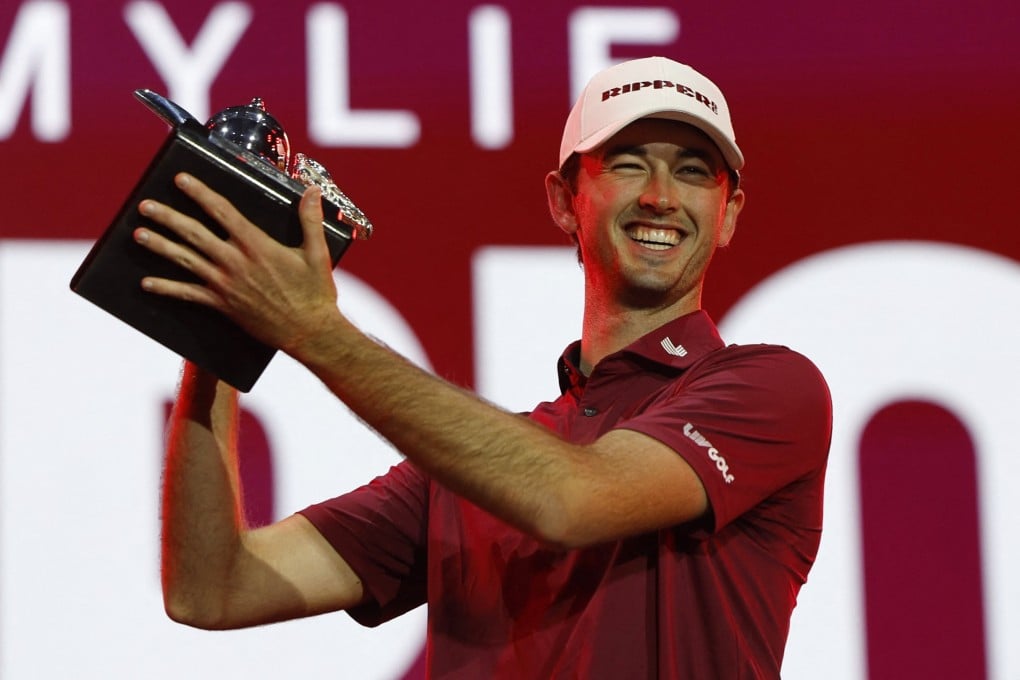 Elvis Smylie celebrates with the LIV Golf Riyadh trophy after pipping Jon Rahm to the title. Photo: Reuters