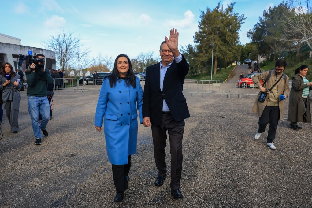 Presidential candidate Antonio Jose Seguro, right, and his wife Margarida Maldonado Freitas greet people after voting in the second round of the Portuguese presidential elections, in Caldas da Rainha, Portugal on Sunday. Photo: EPA