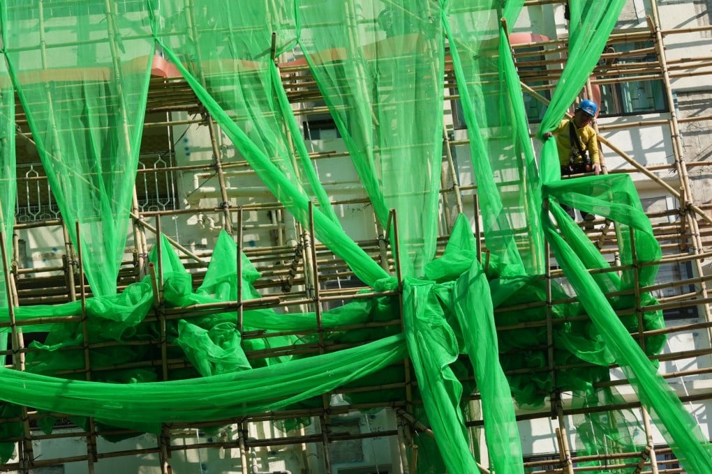 Workers put up new fire-retardant scaffolding nets in Tin Hau last month. Photo: Jelly Tse