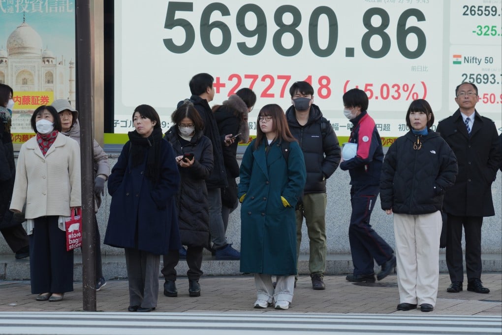 People stand in front of an electronic board showing Japan’s Nikkei index at a securities firm on February 9, 2026, in Tokyo. Photo: AP Photo