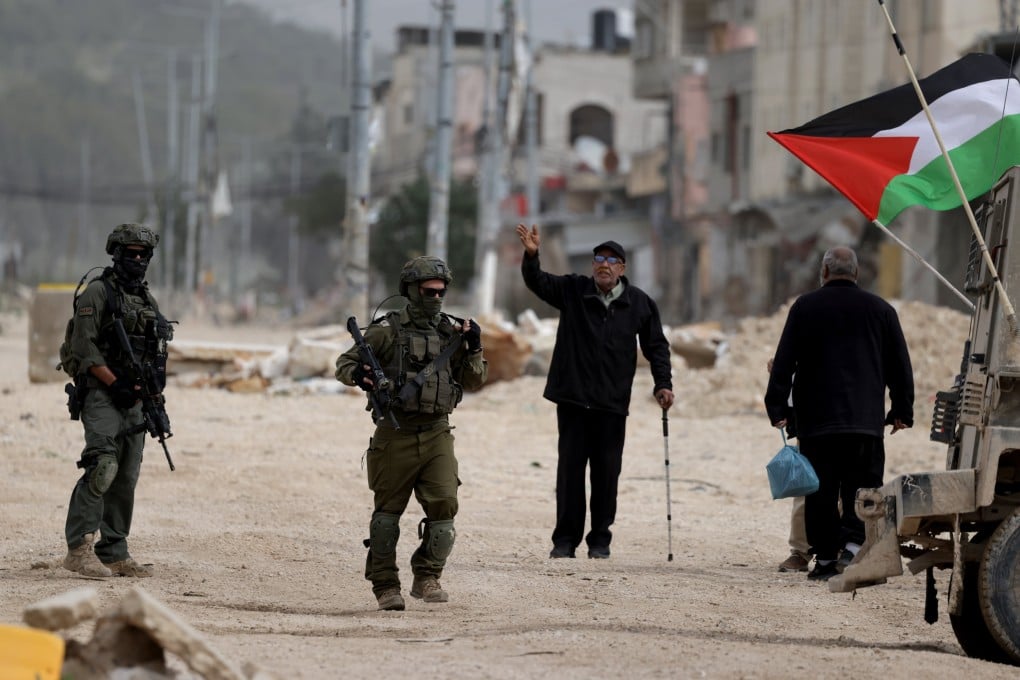Israeli troops stop displaced Palestinians attempting to return to a refugee camp during an Israeli military operation on Monday: Photo: EPA