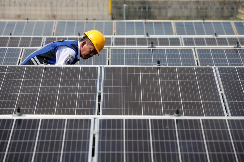 A technician checks and cleans solar panels at a bus station in Depok, Indonesia. The Southeast Asian country has set its sights on cooperating with China to lower emissions and fix environmental problems while strengthening infrastructure, energy and technology developments. Photo: EPA-EFE