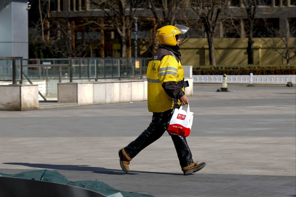 A delivery driver rushes with an order on February 8, 2026, in Beijing. Photo: Getty Images