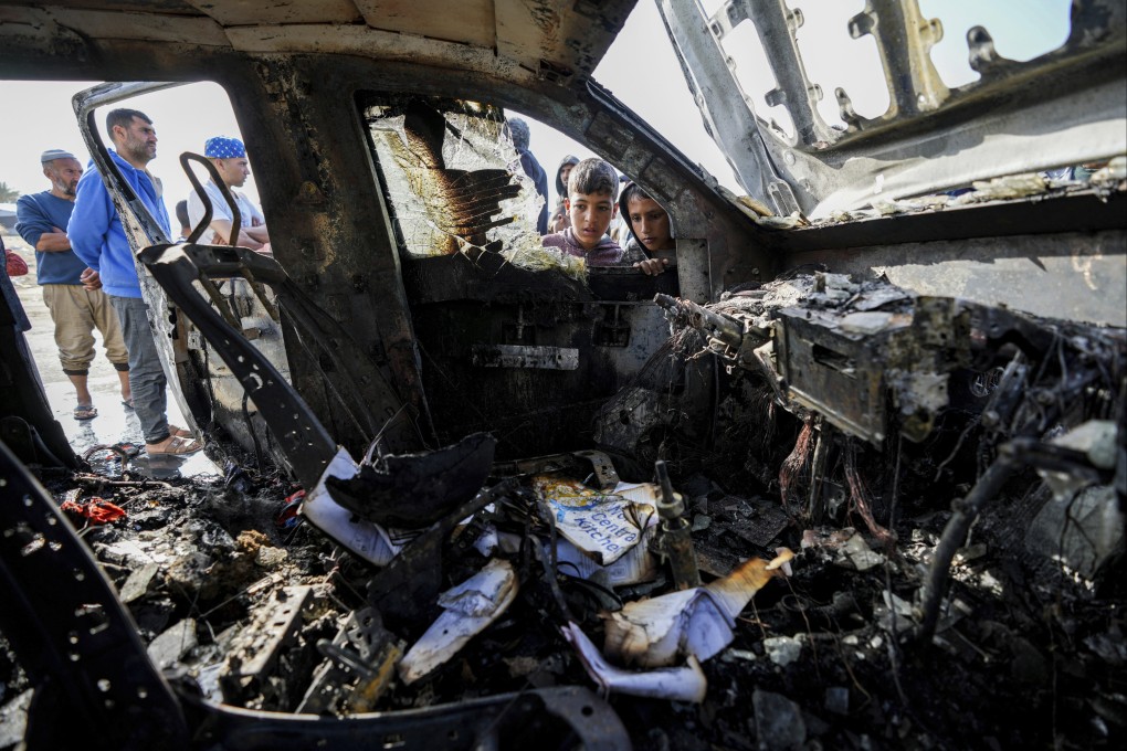 People inspect the site where World Central Kitchen workers were killed in the Gaza Strip in April 2024. Photo: AP