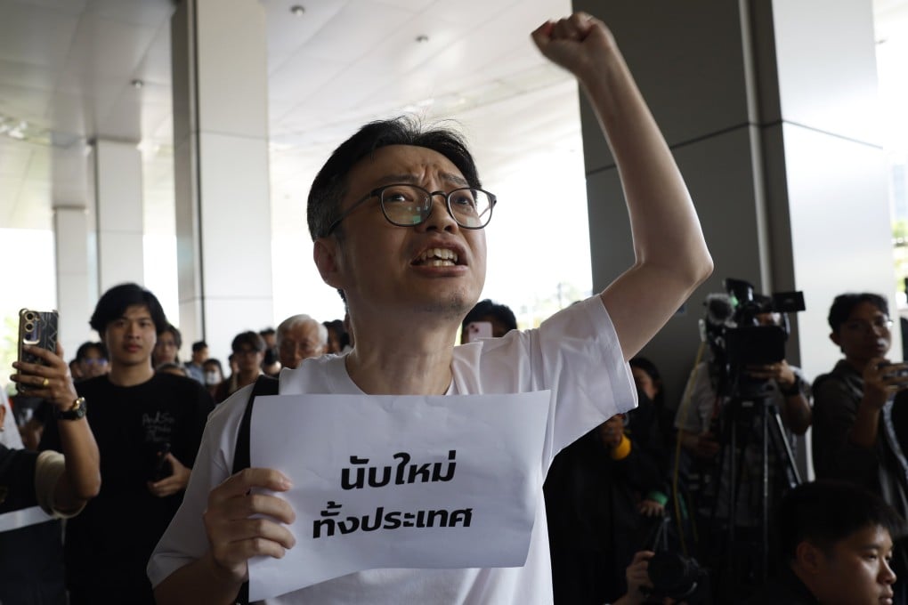 A Thai demonstrator holding a banner reading “nationwide vote recount” shouts slogans during a protest at the Office of The Election Commission of Thailand in Bangkok on Wednesday. Photo: EPA