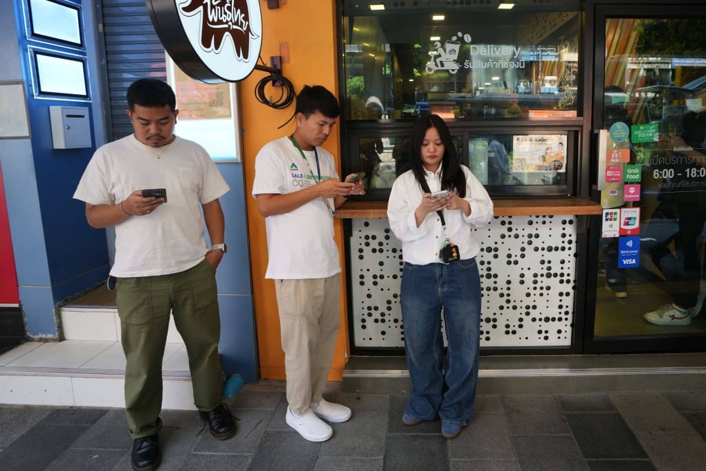 Customers wait for their coffee outside a coffee shop in Bangkok, Thailand on Wednesday. Photo: AP