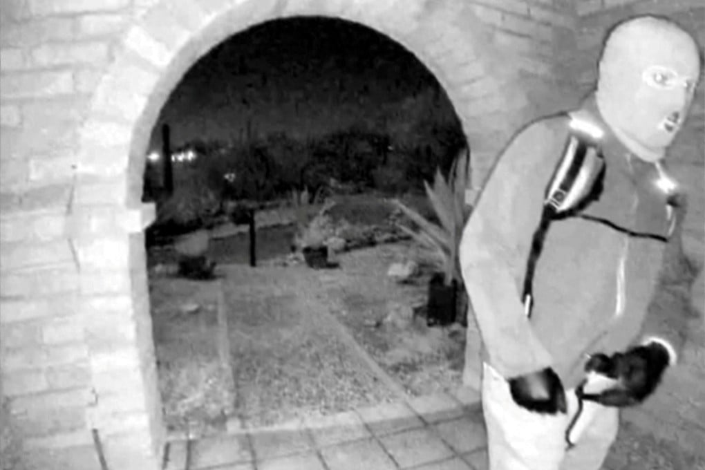 A masked individual at Nancy Guthrie’s front door the morning of her disappearance. Photo: Pima County Sheriff’s Department via Reuters