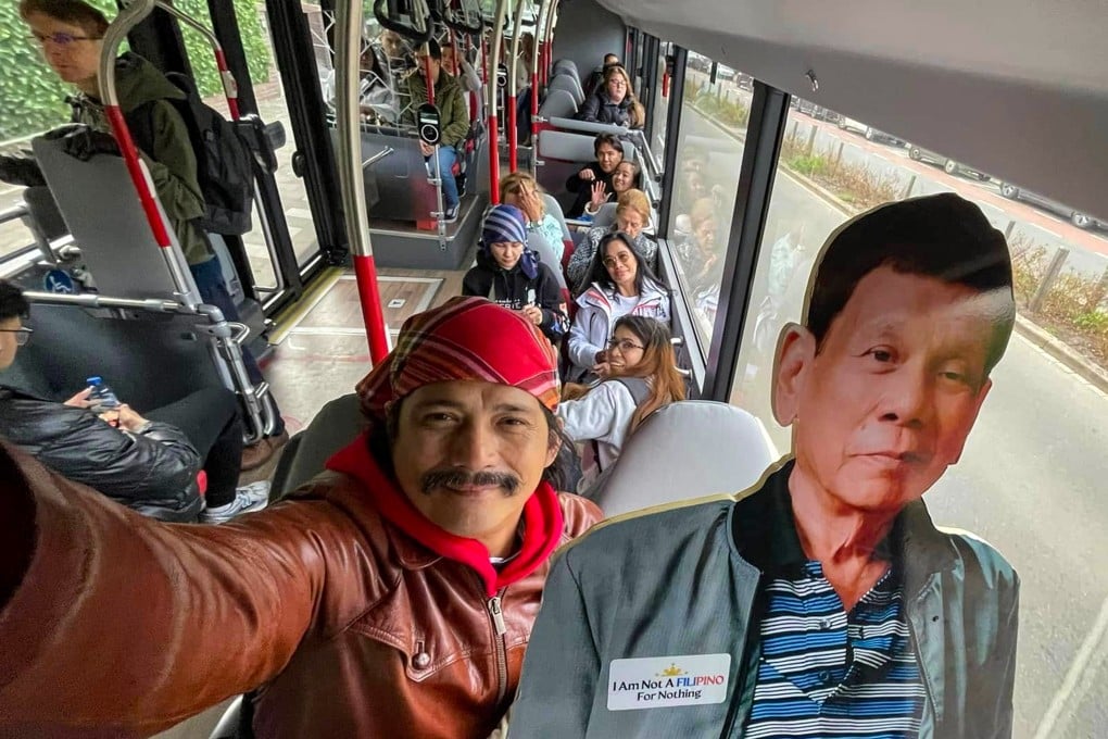 Philippine Senator Robin Padilla carrying a cardboard cutout of ex-president Rodrigo Duterte on a bus. Photo: handout