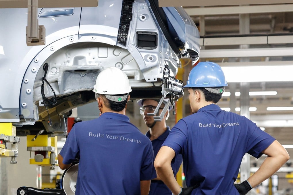 Workers work on BYD vehicles on the production line in the Chinese company’s electric vehicle factory at the Industrial Complex in Camacari, Bahia, Brazil on February 3. As Chinese technology firms expanding across Brazilian infrastructure and both countries navigate AI adoption,  this partnership offers ground for addressing the human cost of adaptation. Photo: Reuters