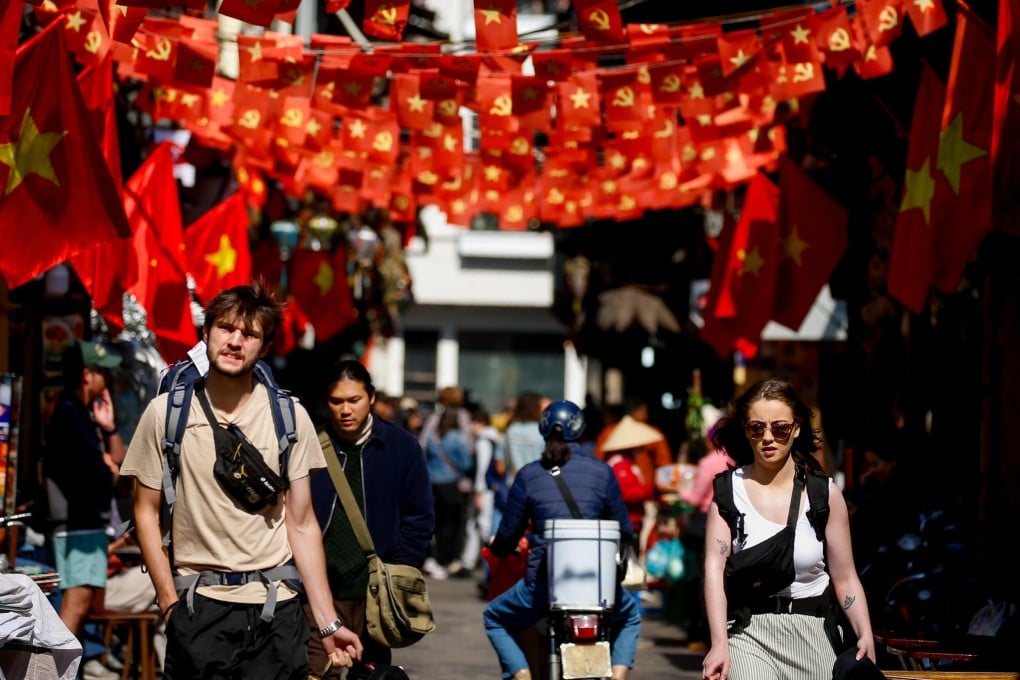 Tourists walk at a street in Hanoi, Vietnam last month. Photo: EPA