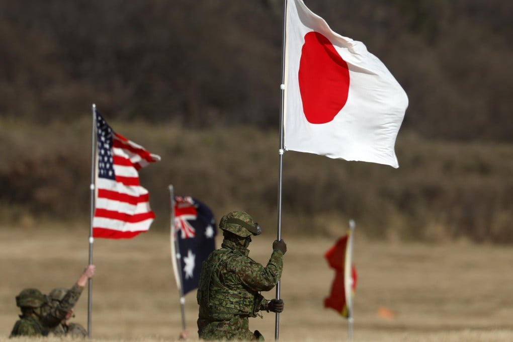 Military personnel hold national flags of Japan and the US during a Japan Ground Self-Defence Force training at Camp Narashino, near Tokyo, on January 11. Photo: EPA