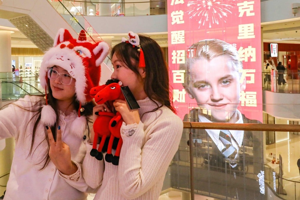 Shoppers take a selfie in front of a poster featuring Tom Felton as his Harry Potter character Draco Malfoy at a mall in Shangqiu, in China’s central Henan province. Find out more about how the Year of the Horse influences Chinese culture, from fireworks to linguistics, and why Draco Malfoy is an unexpected Lunar New Year icon. Photo: AFP